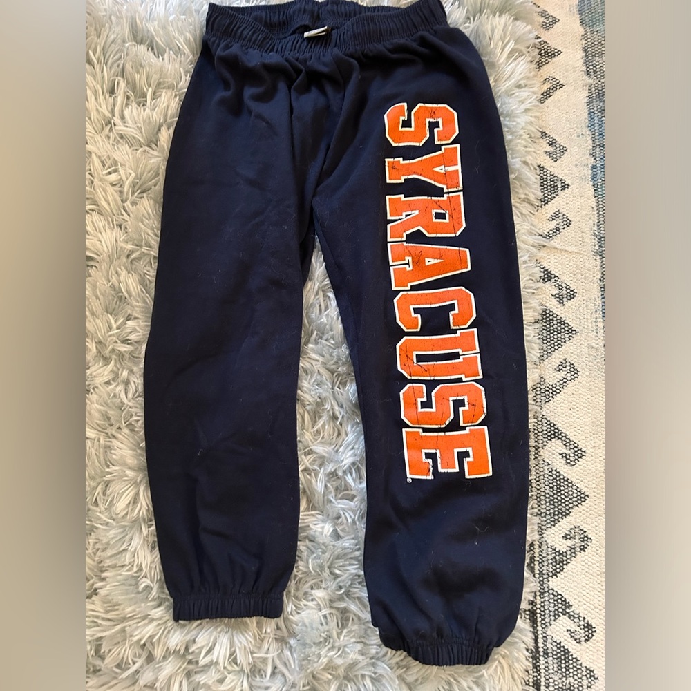 Syracuse blue sweatpants with orange vertical lettering